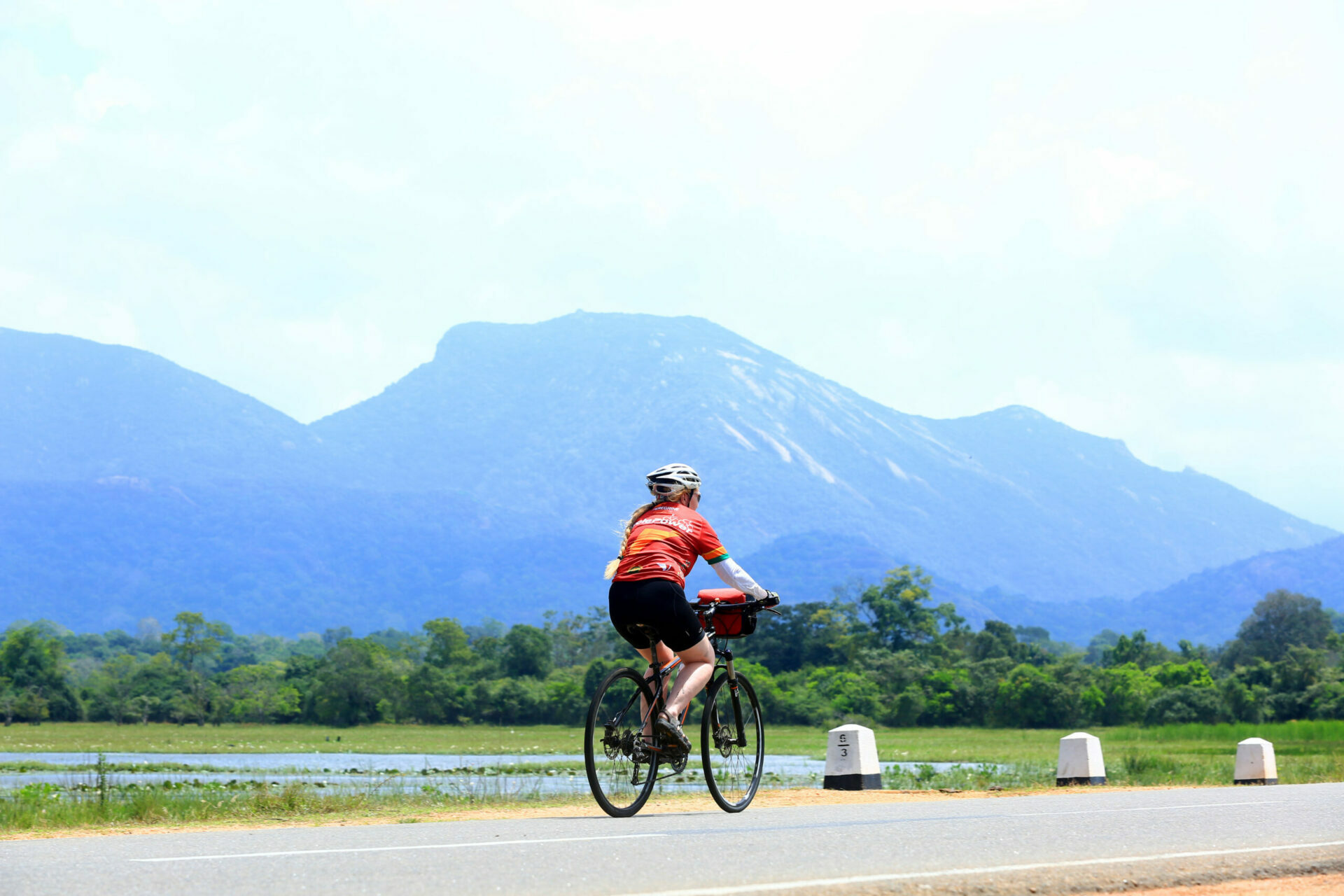 A tourist lady experiencing their cycling tour in Sri Lanka